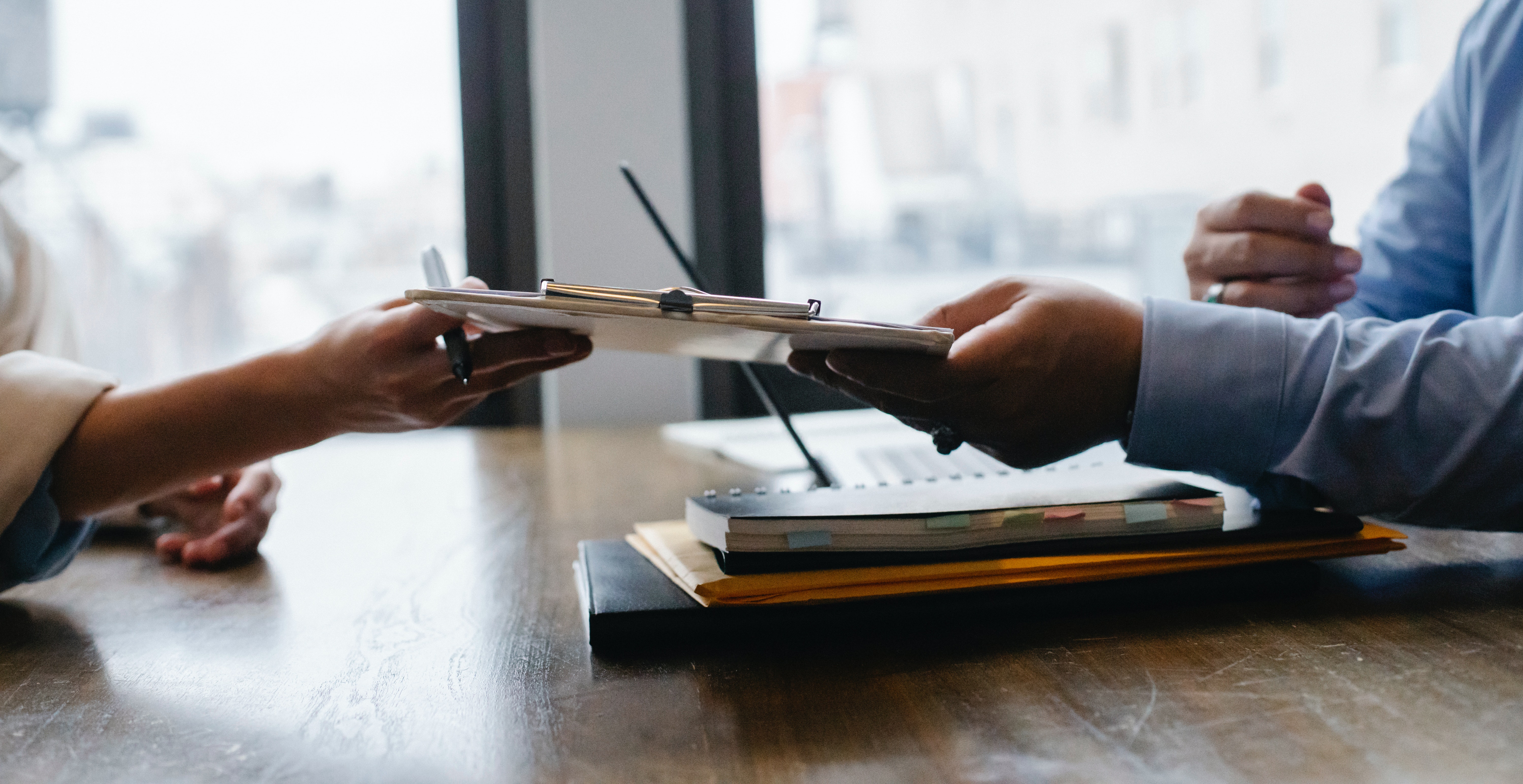 Crop black job candidate passing resume to HR employee
