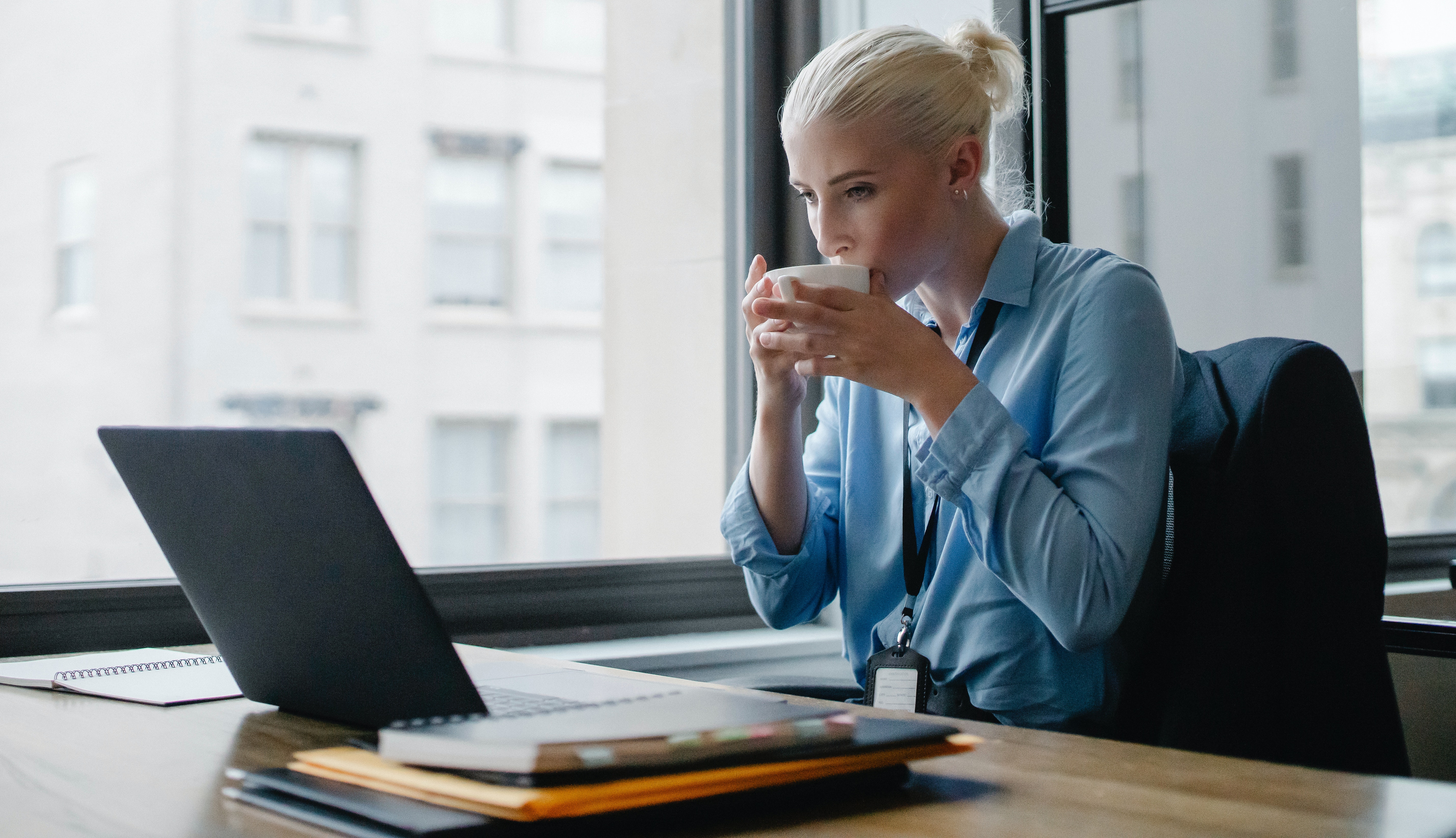 Female manager drinking coffee at workplace
