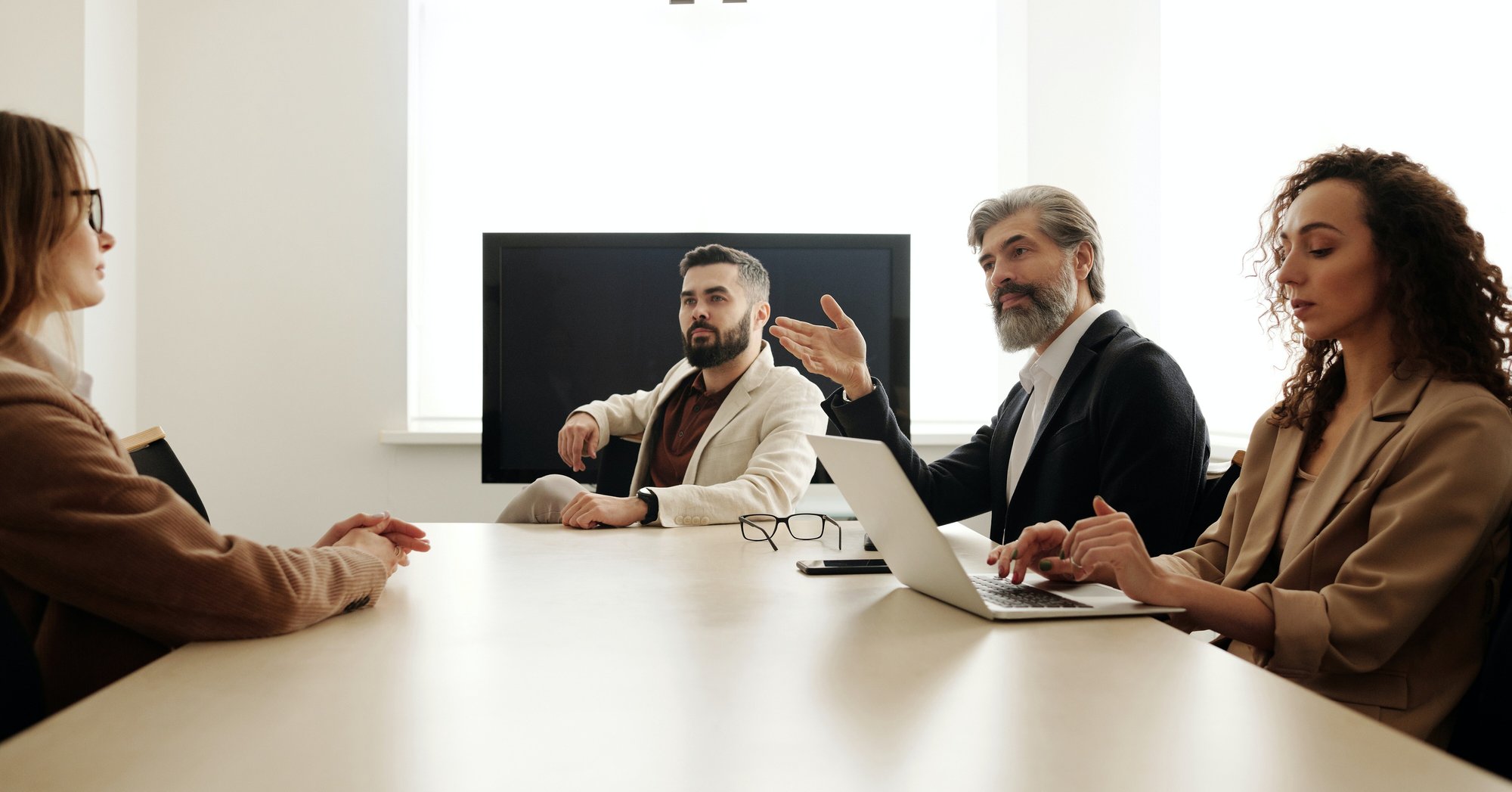a group of executives having a conversation in a board room