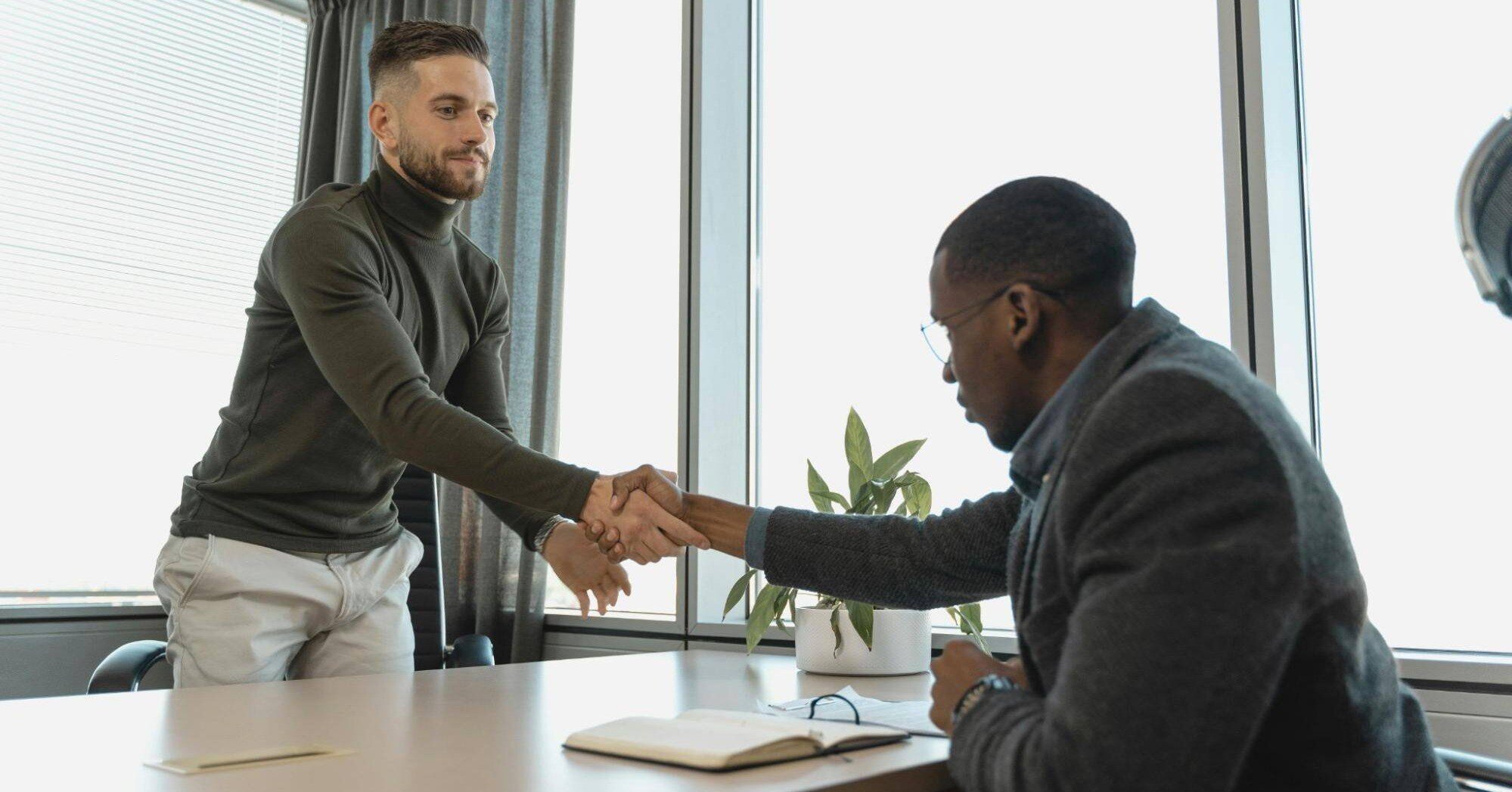 an employer and job seeker shaking hands during a job interview