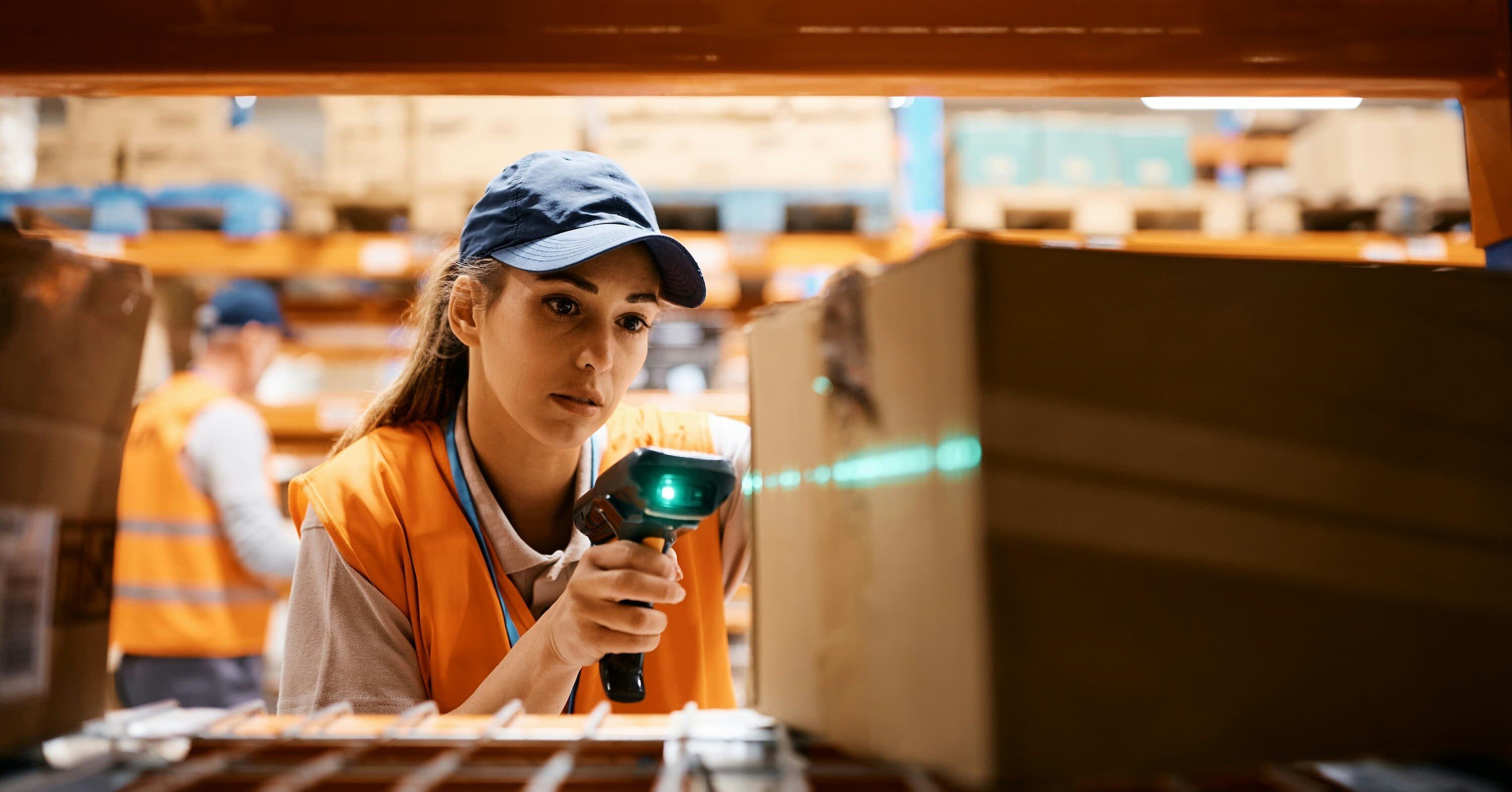 a warehouse clerk scanning a package